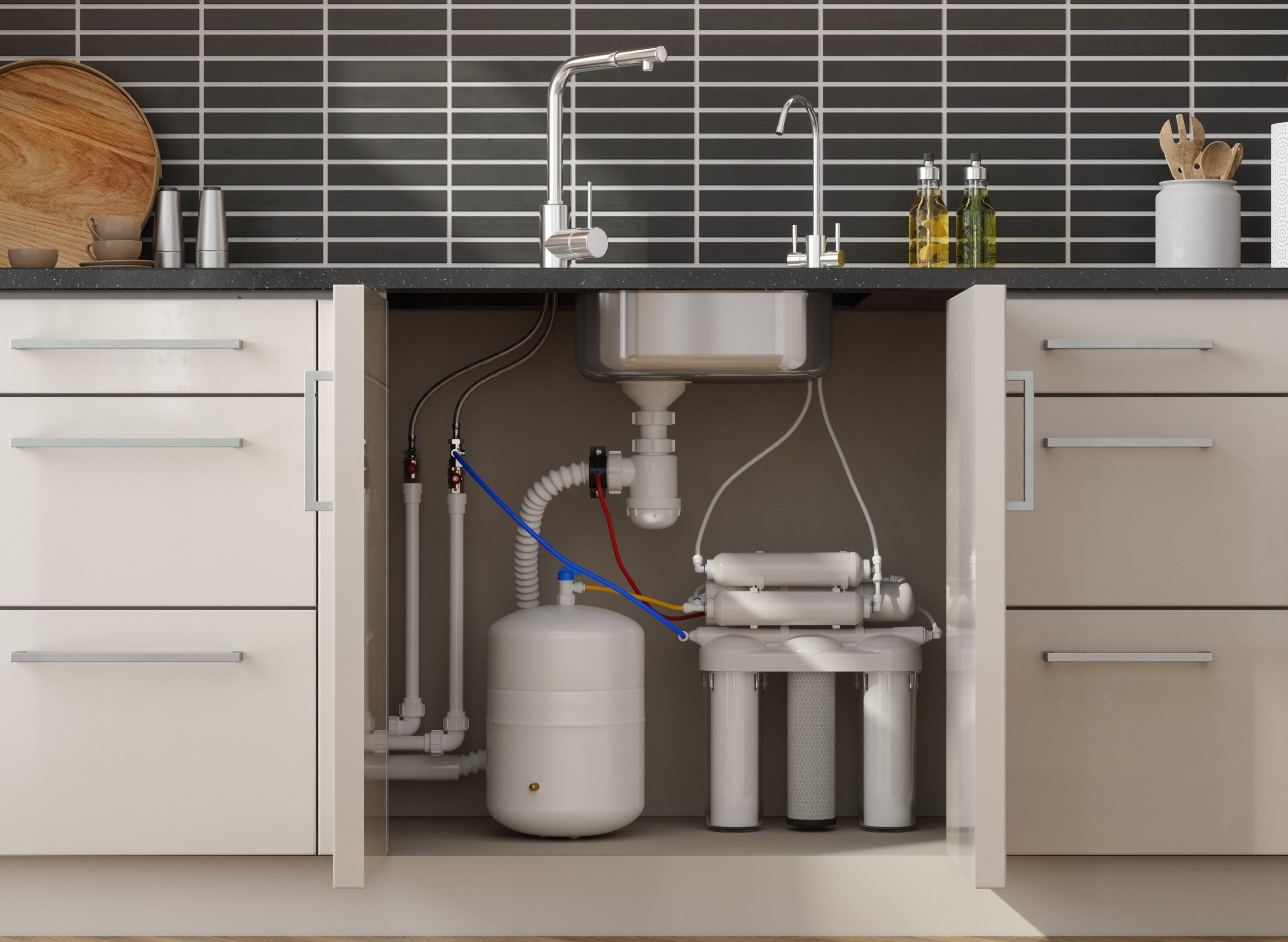 Kitchen sink with open cabinet showing plumbing.