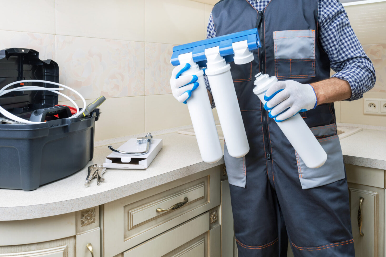 Technician installing a water filtration system.